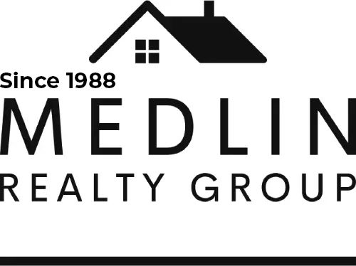 A black and white logo of medlin realty group