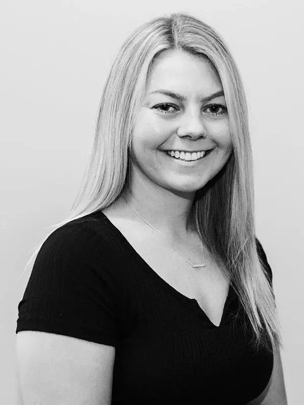 A woman with long blonde hair wearing black shirt.