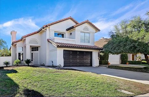 A large white house with a garage door.