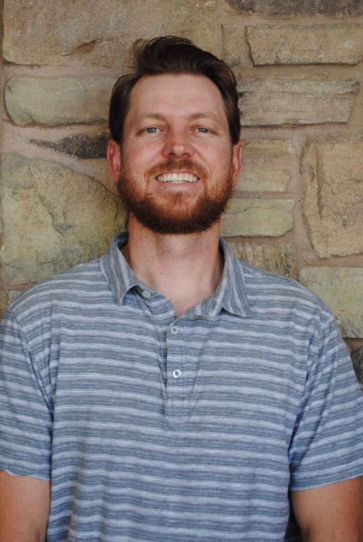 Smiling bearded man in striped polo